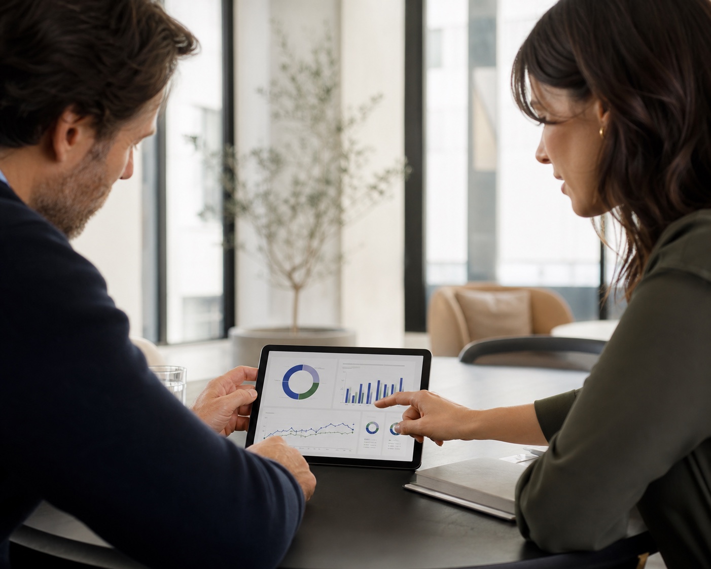 Business owner and accountant reviewing a financial performance dashboard
